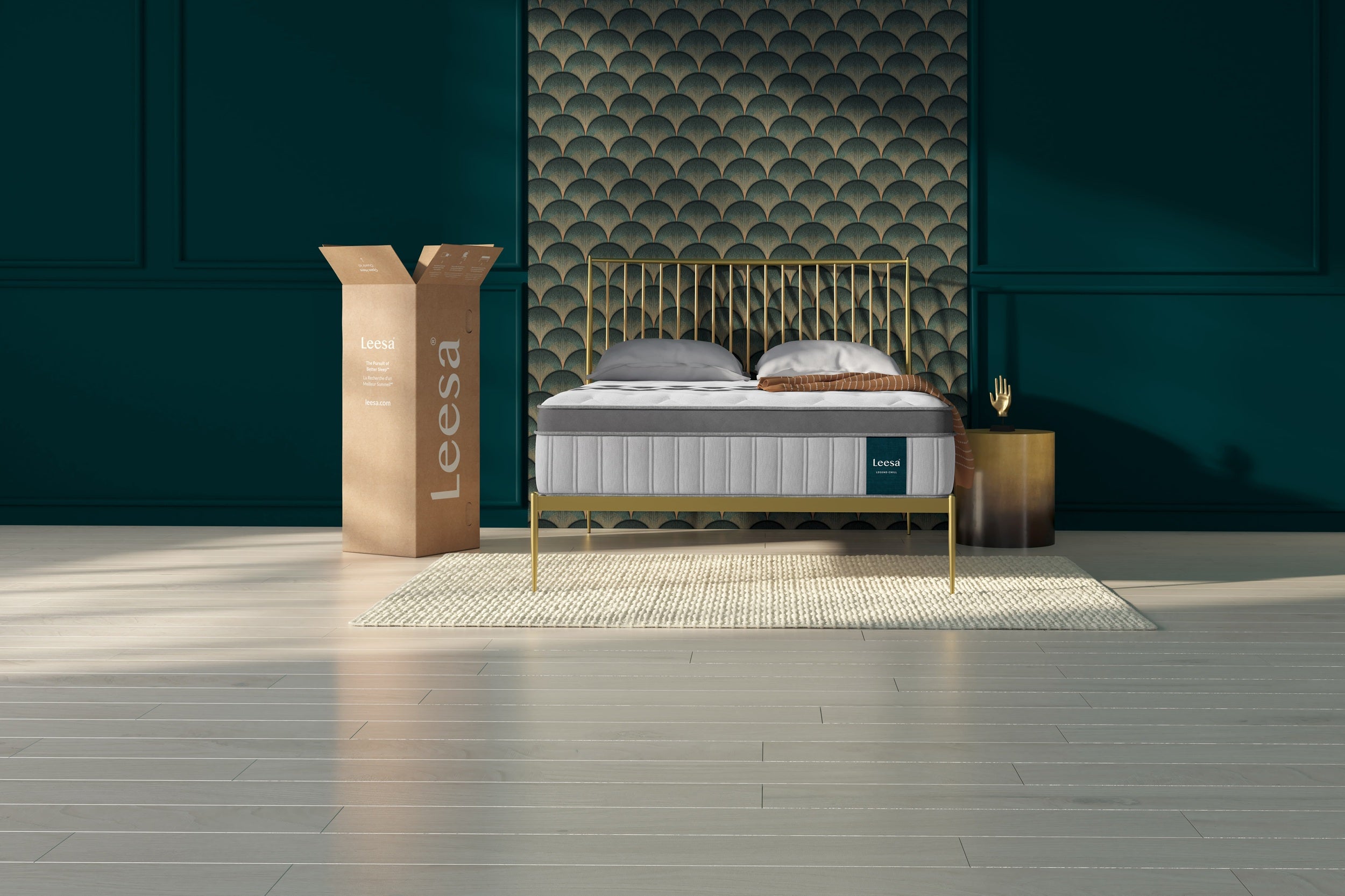 Leesa mattress in a bedroom setting with a decorative wall and packaging box.