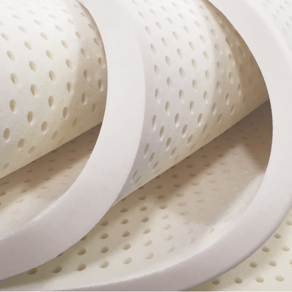Close-up of a white mattress topper with a honeycomb pattern